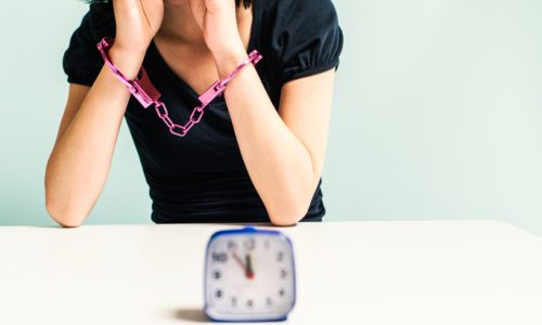 Handcuffed woman and the time