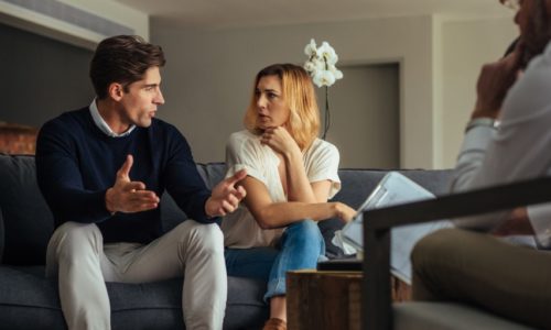 Couple arguing during therapy session with psychologist