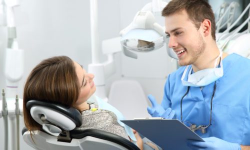 Dentist explaining dental treatment procedure to a patient