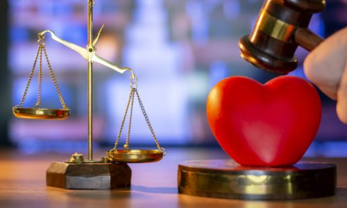 Justice Gavel and stethoscope with red heart on background.law concept